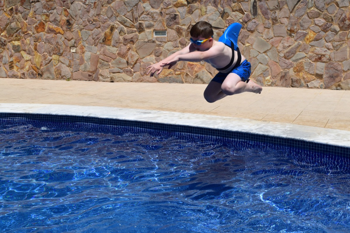 Sam jumping in the pool